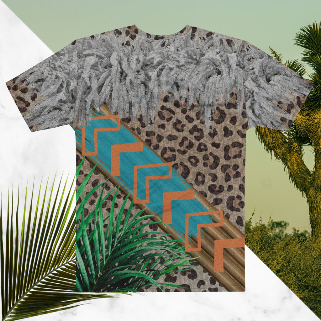 Full color all over print graphic tee shirt with detailed leopard print background, diagonal wood slats from one corner to the other a bold sky blue brush stroke across the wood overlayed with neon orange solid and opaque Memphis Design style boomerang shapes at the top is an overhang of 3d detailed white fern leaves and a tropical plant in foreground