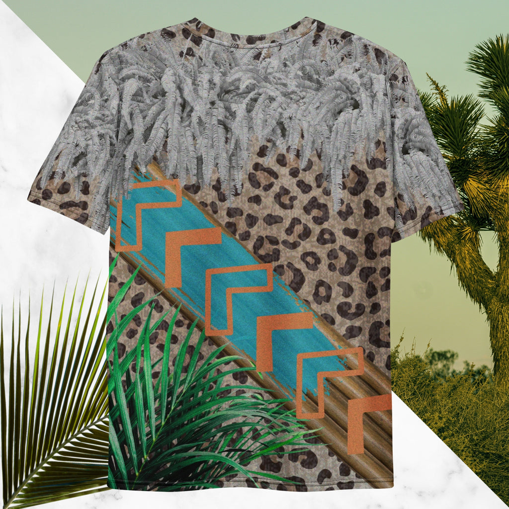 Full color all over print graphic tee shirt with detailed leopard print background, diagonal wood slats from one corner to the other a bold sky blue brush stroke across the wood overlayed with neon orange solid and opaque Memphis Design style boomerang shapes at the top is an overhang of 3d detailed white fern leaves and a tropical plant in foreground