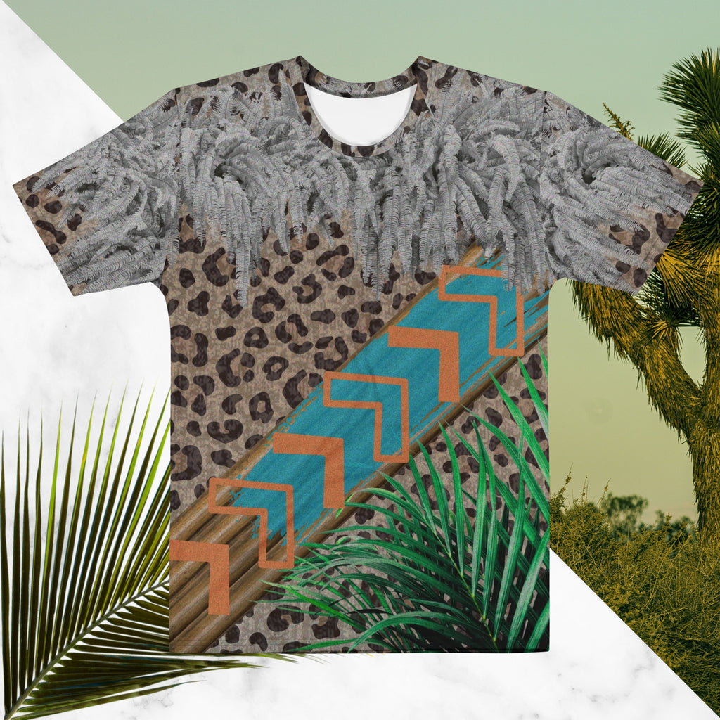 Full color all over print graphic tee shirt with detailed leopard print background, diagonal wood slats from one corner to the other a bold sky blue brush stroke across the wood overlayed with neon orange solid and opaque Memphis Design style boomerang shapes at the top is an overhang of 3d detailed white fern leaves and a tropical plant in foreground