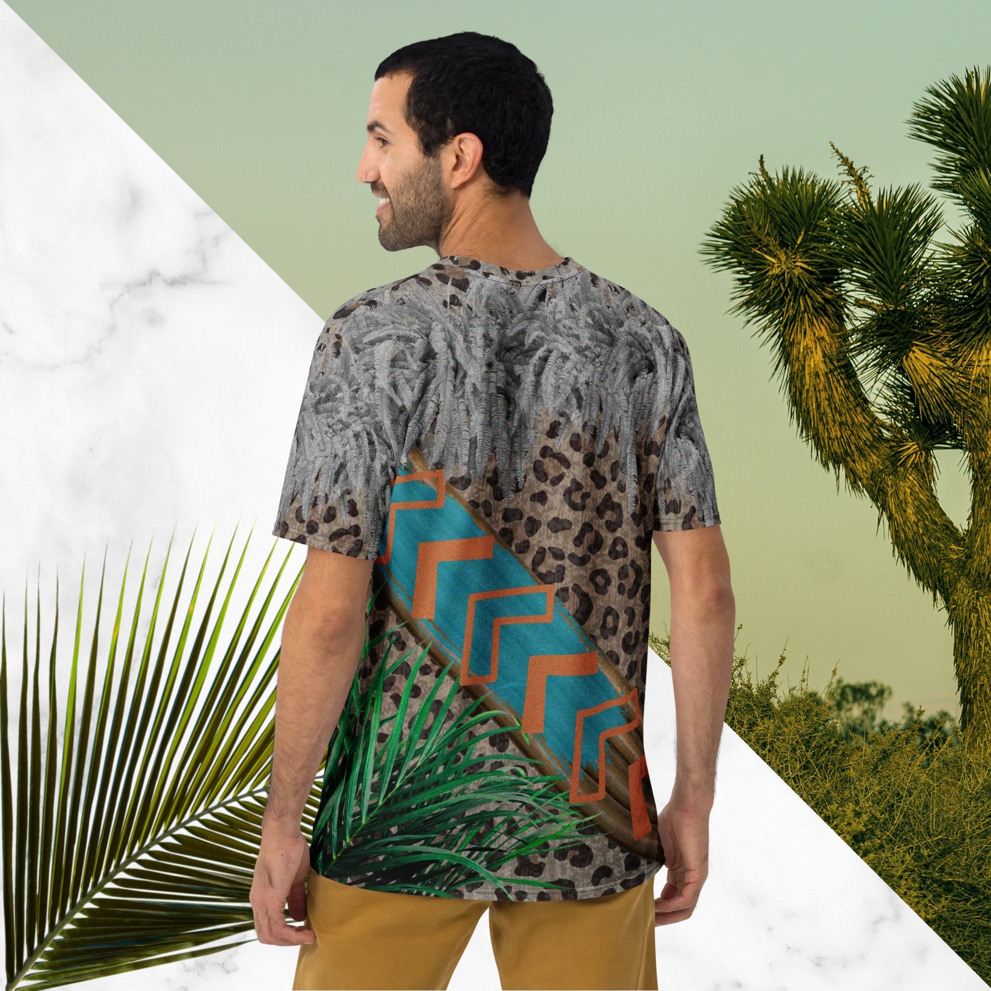 Full color all over print graphic tee shirt with detailed leopard print background, diagonal wood slats from one corner to the other a bold sky blue brush stroke across the wood overlayed with neon orange solid and opaque Memphis Design style boomerang shapes at the top is an overhang of 3d detailed white fern leaves and a tropical plant in foreground
