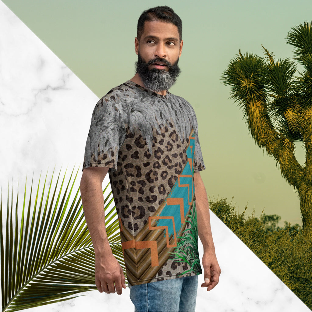 Full color all over print graphic tee shirt with detailed leopard print background, diagonal wood slats from one corner to the other a bold sky blue brush stroke across the wood overlayed with neon orange solid and opaque Memphis Design style boomerang shapes at the top is an overhang of 3d detailed white fern leaves and a tropical plant in foreground