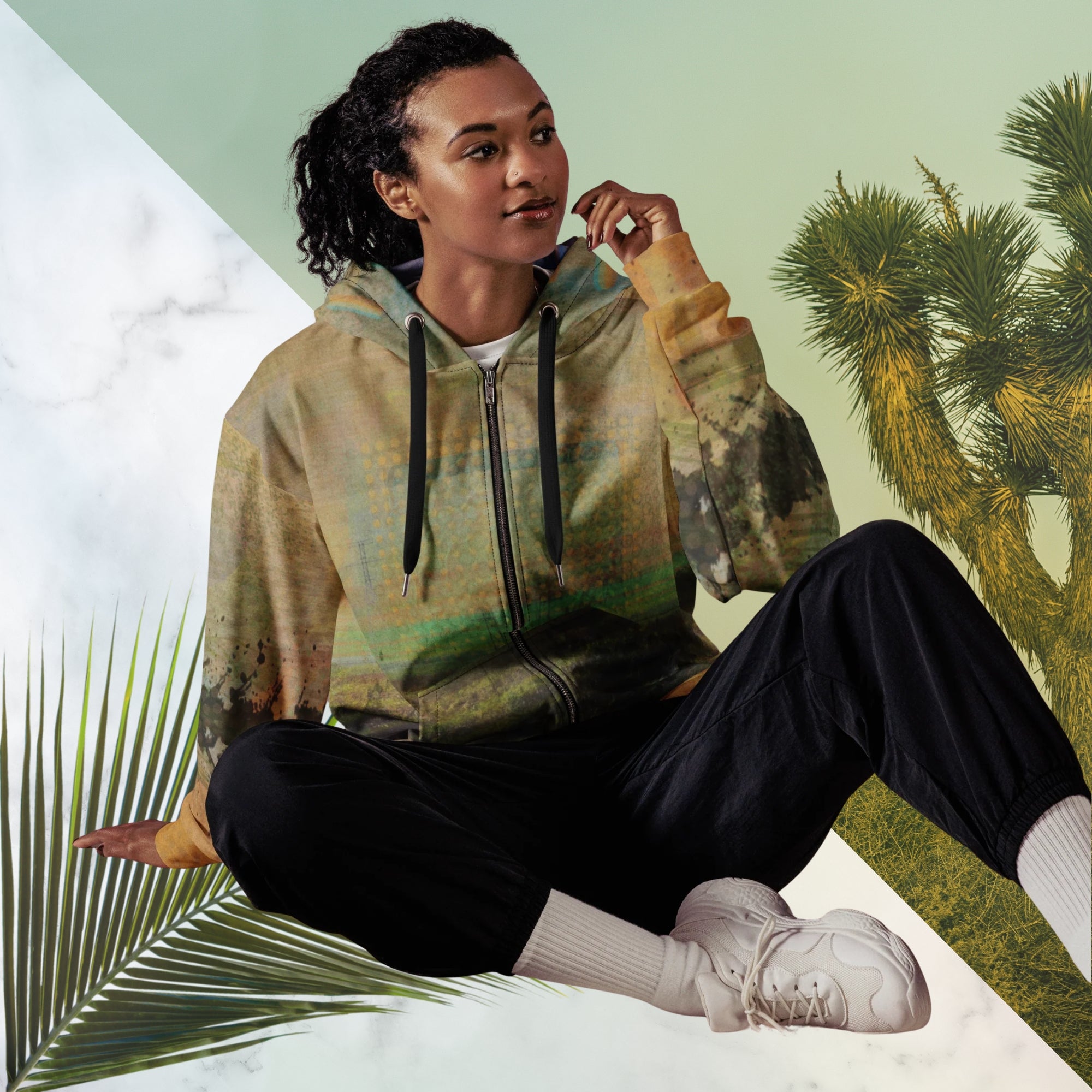 Multicolored primarily orange all over print zip hoodie depicting a long distance view of trees and power lines with vintage 90s style distortion abstract orange dot grids line patterns in shades of green and yellow black ink splotch lines and the background appearing as a painted canvas jungle plants and graphic lines overlayed on the sleeves