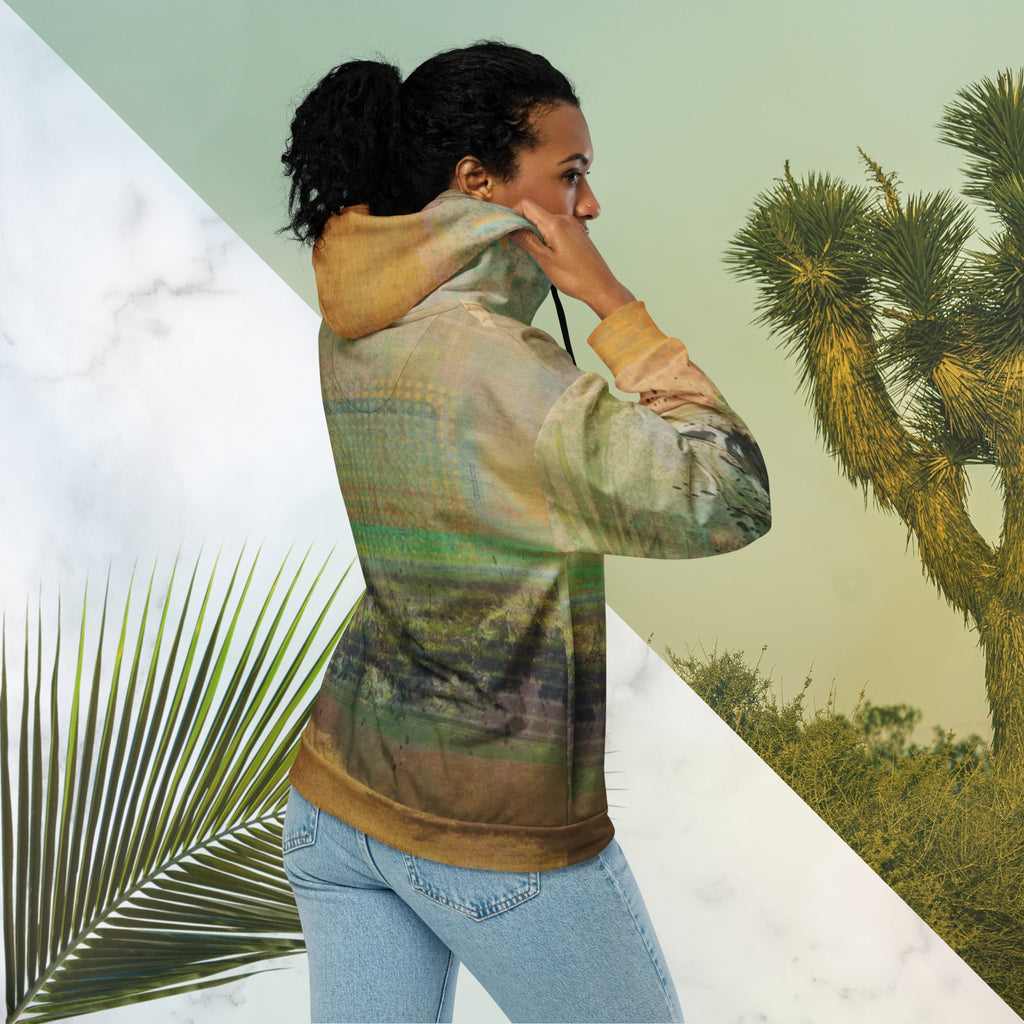 Multicolored primarily orange all over print zip hoodie depicting a long distance view of trees and power lines with vintage 90s style distortion abstract orange dot grids line patterns in shades of green and yellow black ink splotch lines and the background appearing as a painted canvas jungle plants and graphic lines overlayed on the sleeves