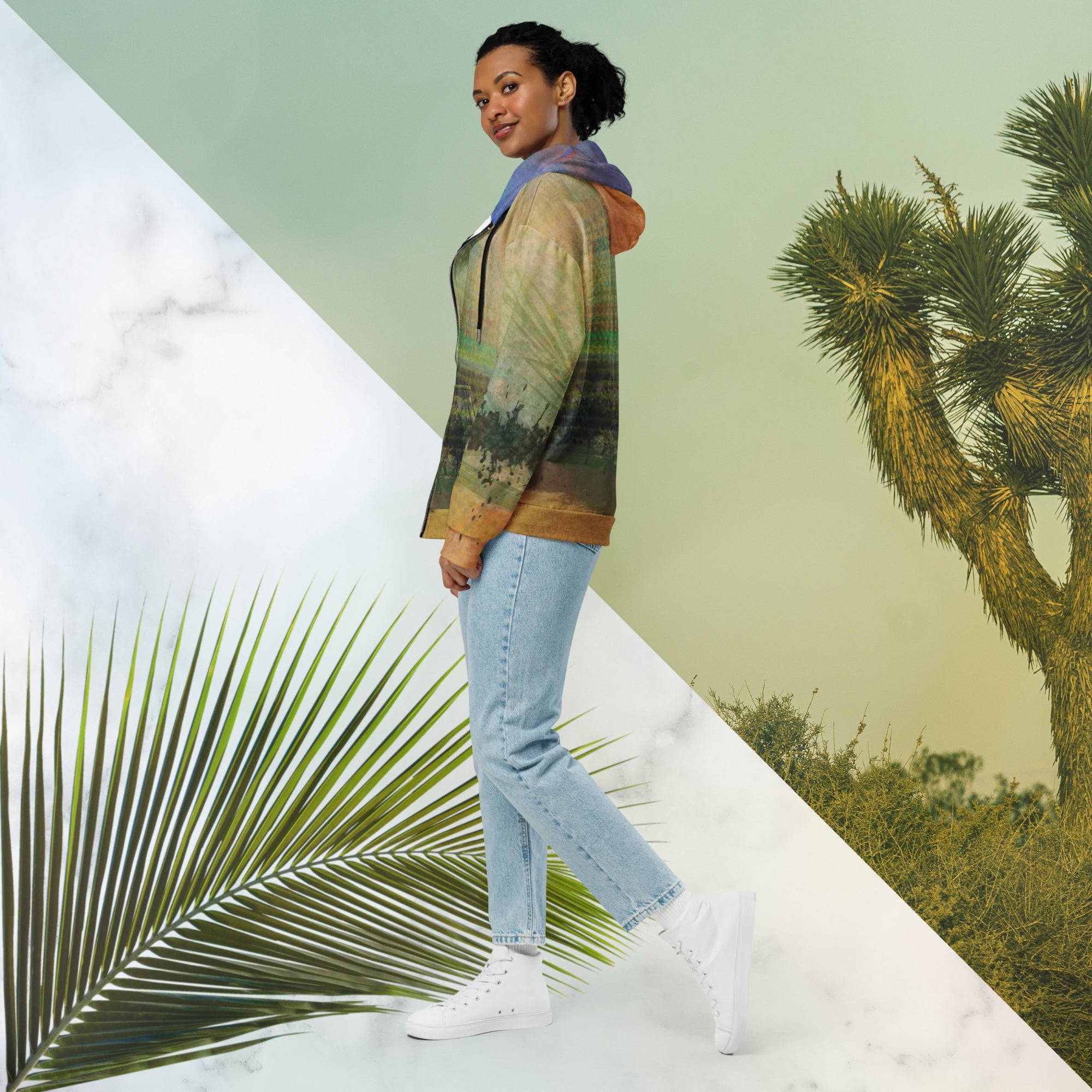 Multicolored primarily orange all over print zip hoodie depicting a long distance view of trees and power lines with vintage 90s style distortion abstract orange dot grids line patterns in shades of green and yellow black ink splotch lines and the background appearing as a painted canvas jungle plants and graphic lines overlayed on the sleeves