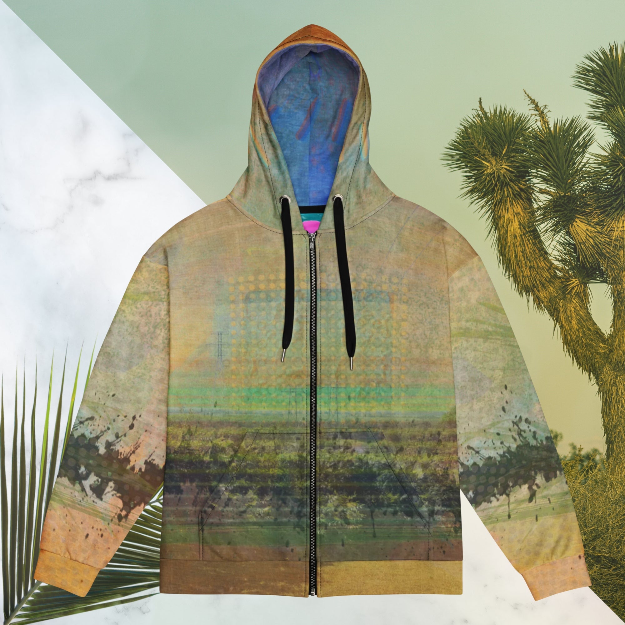 Multicolored primarily orange all over print zip hoodie depicting a long distance view of trees and power lines with vintage 90s style distortion abstract orange dot grids line patterns in shades of green and yellow black ink splotch lines and the background appearing as a painted canvas jungle plants and graphic lines overlayed on the sleeves