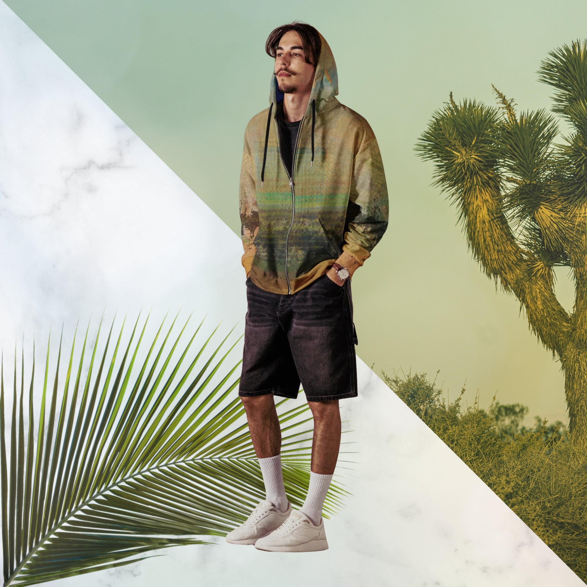 Multicolored primarily orange all over print zip hoodie depicting a long distance view of trees and power lines with vintage 90s style distortion abstract orange dot grids line patterns in shades of green and yellow black ink splotch lines and the background appearing as a painted canvas jungle plants and graphic lines overlayed on the sleeves