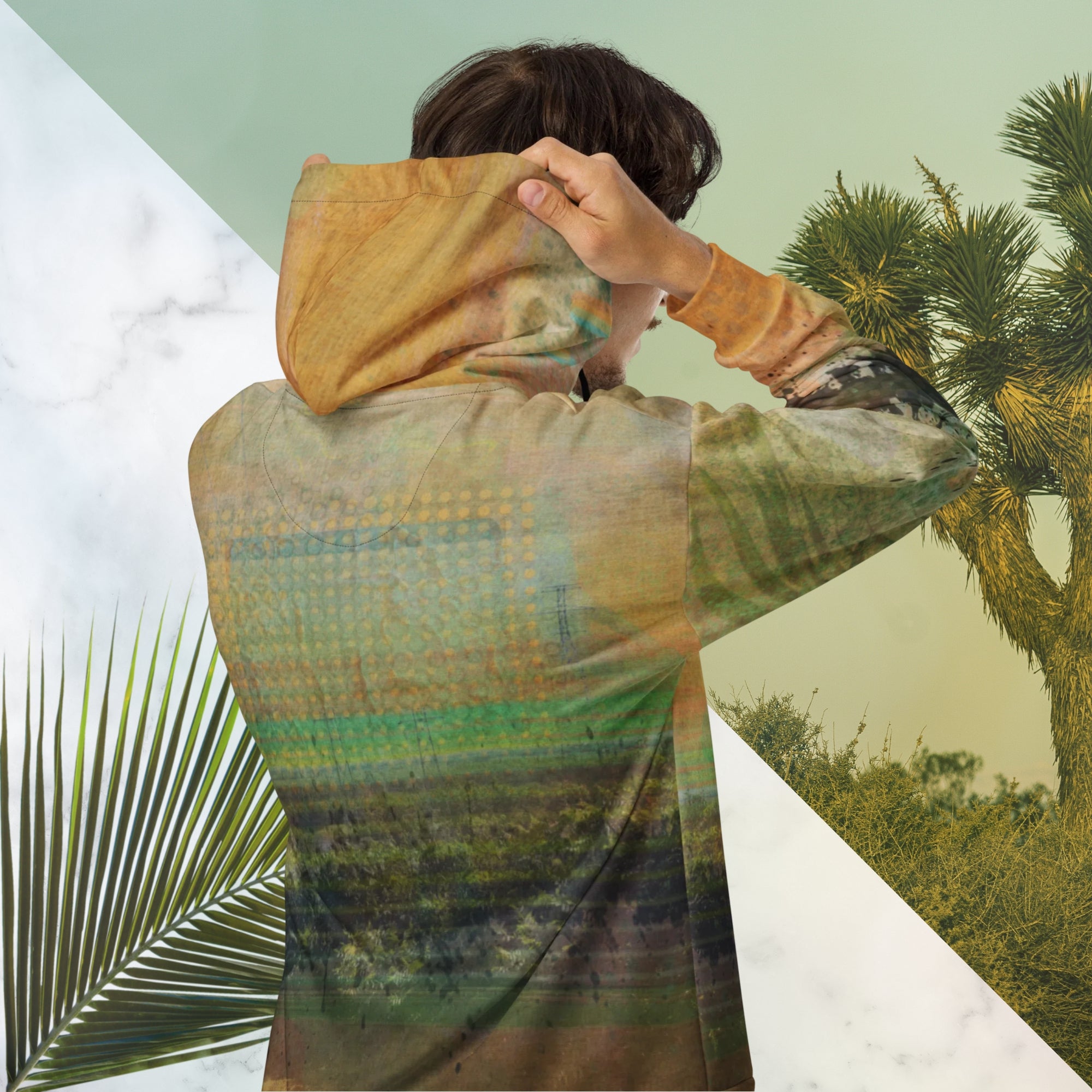 Multicolored primarily orange all over print zip hoodie depicting a long distance view of trees and power lines with vintage 90s style distortion abstract orange dot grids line patterns in shades of green and yellow black ink splotch lines and the background appearing as a painted canvas jungle plants and graphic lines overlayed on the sleeves