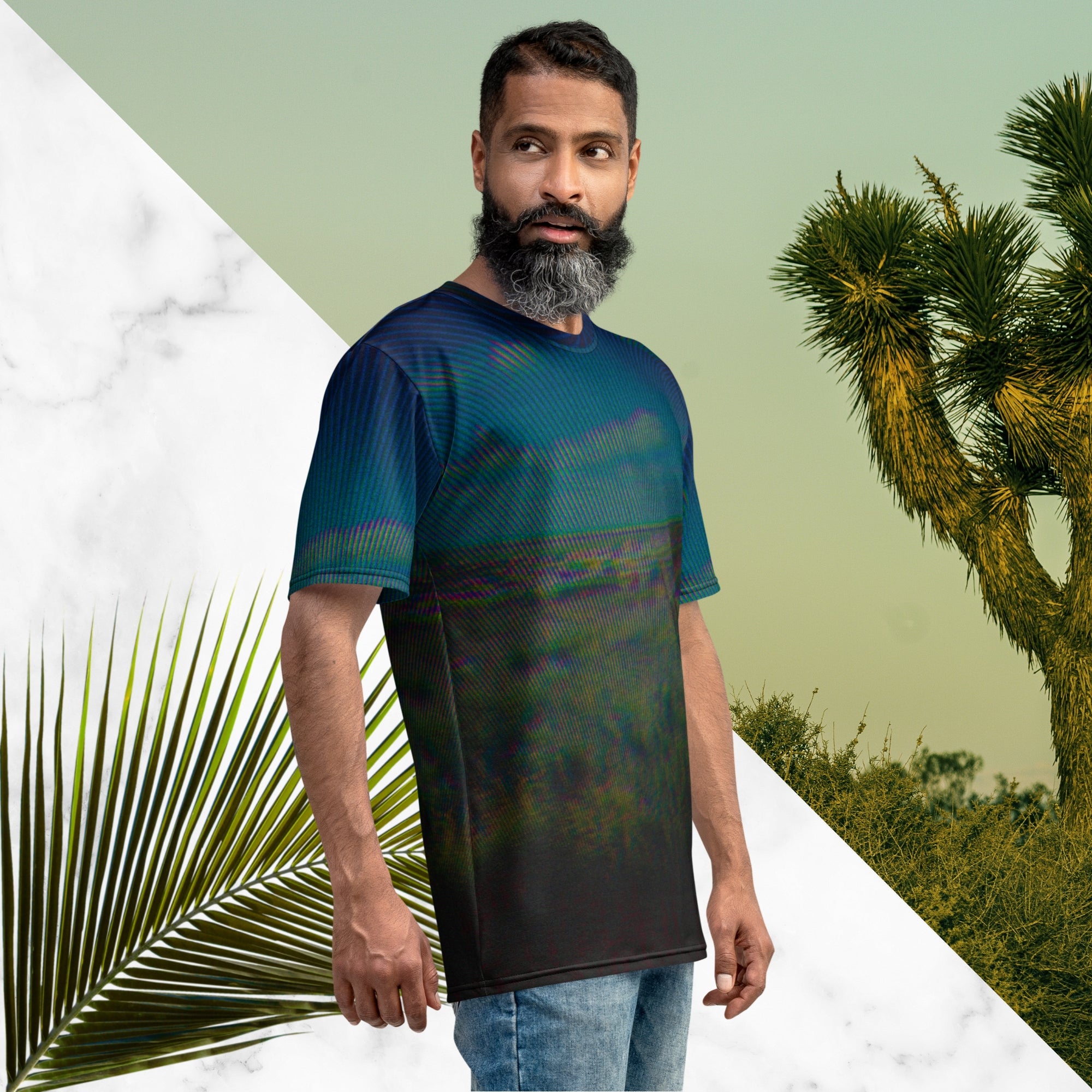 Full color all over print graphic tee shirt with image of a desert and green desert plants and blue sky with clouds above the horizon overlayed with rgb distortion and psychedelic lines graphics fanning outward towards the top