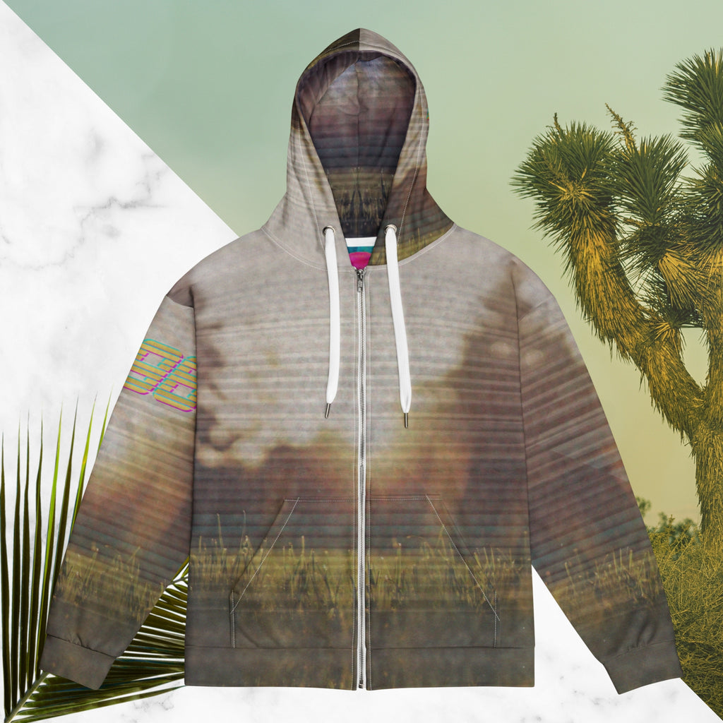 Multicolored all over print zip hoodie with full color 90s photo of sun setting through trees with grass in foreground overlayed with retro tv distortion and scan lines with grainy vhs effect transparent whit bars graphic in rhombus shape on left sleeve the numbers 1996 on right sleeve and left side of hood in retro 90s memphis font and retro jazz squiggle on back blending with colors