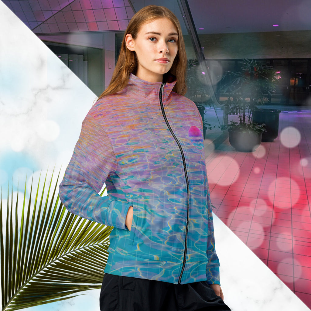 Multicolored all over print track jacket depicting blue water reflecting the colors of the sunset in oranges and pinks intensifying towards the top overlayed with a transparent thin white grid with tropical plant silhouettes of tropical plants creating stripe effects on sleeves with Neon Pools vaporwave sun emblem on left chest area