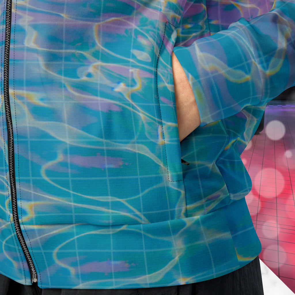 Closeup of pocket on multicolored all over print track jacket depicting blue water reflecting the colors of the sunset in oranges and pinks intensifying towards the top overlayed with a transparent thin white grid with tropical plant silhouettes of tropical plants creating stripe effects on sleeves with Neon Pools vaporwave sun emblem on left chest area