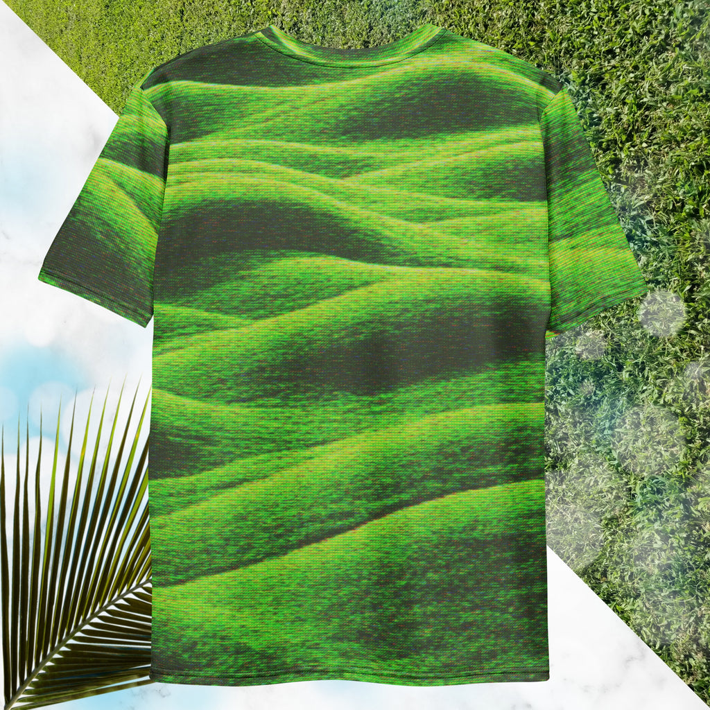 Green and black all over print graphic t-shirt depicting grass covered green rolling hills and their shadows overlayed with detailed v h s and retro t v distortion 