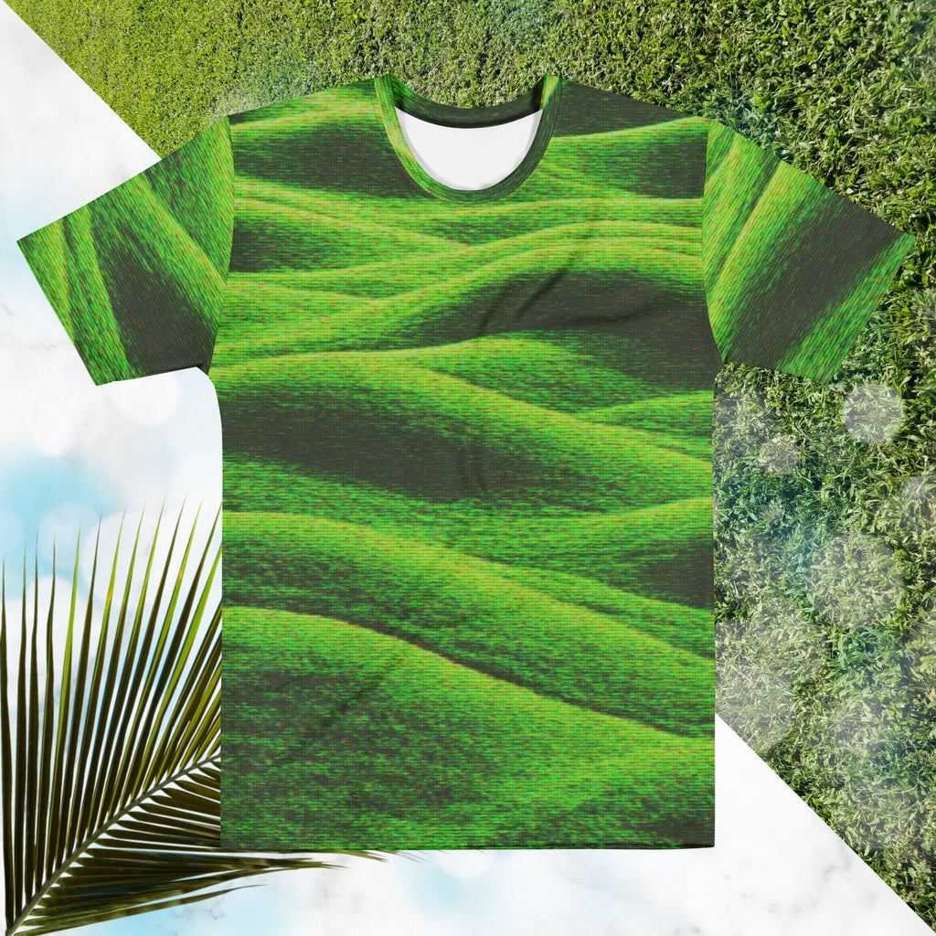 Green and black all over print graphic t-shirt depicting grass covered green rolling hills and their shadows overlayed with detailed v h s and retro t v distortion 