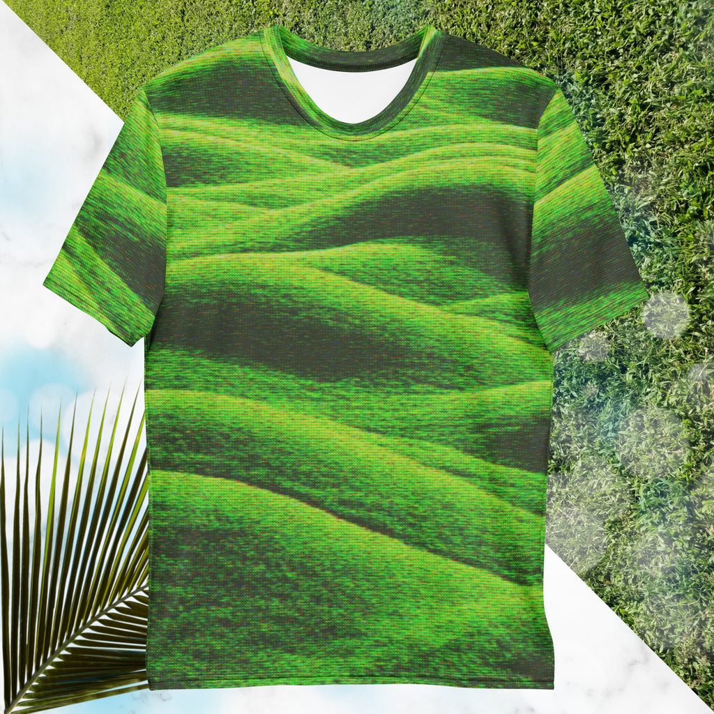Green and black all over print graphic t-shirt depicting grass covered green rolling hills and their shadows overlayed with detailed v h s and retro t v distortion 