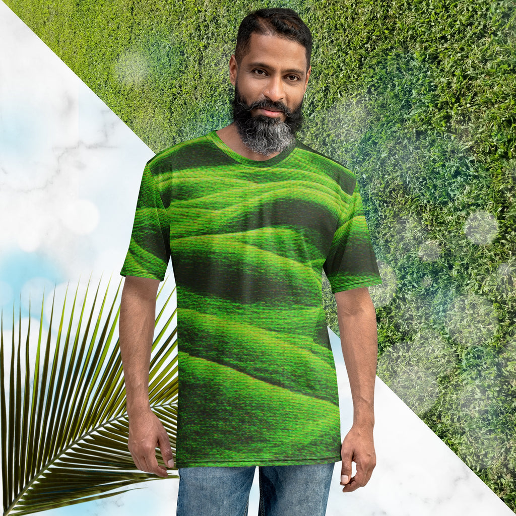Green and black all over print graphic t-shirt depicting grass covered green rolling hills and their shadows overlayed with detailed v h s and retro t v distortion 