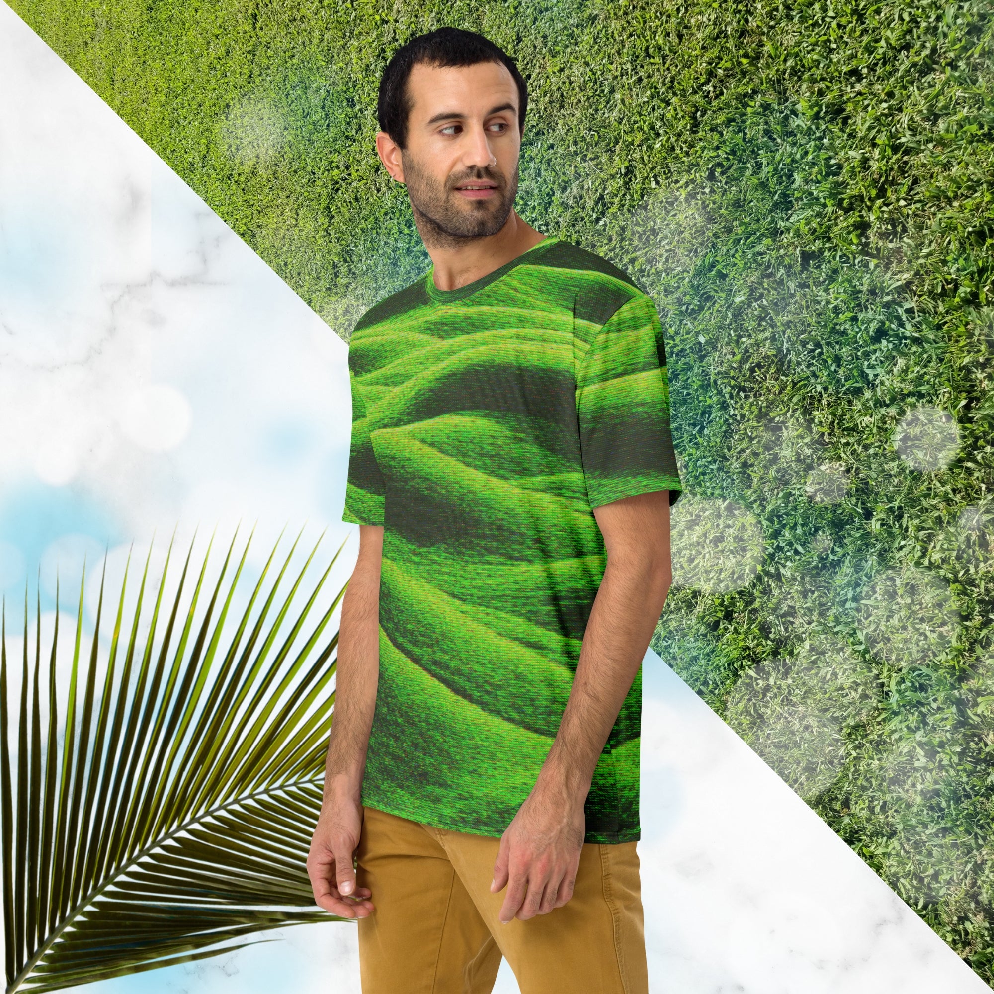 Green and black all over print graphic t-shirt depicting grass covered green rolling hills and their shadows overlayed with detailed v h s and retro t v distortion 