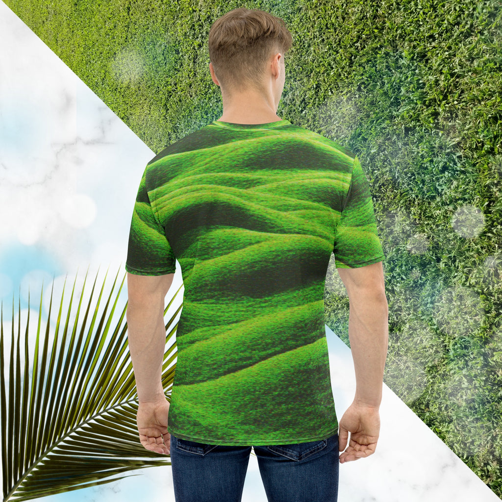 Green and black all over print graphic t-shirt depicting grass covered green rolling hills and their shadows overlayed with detailed v h s and retro t v distortion 