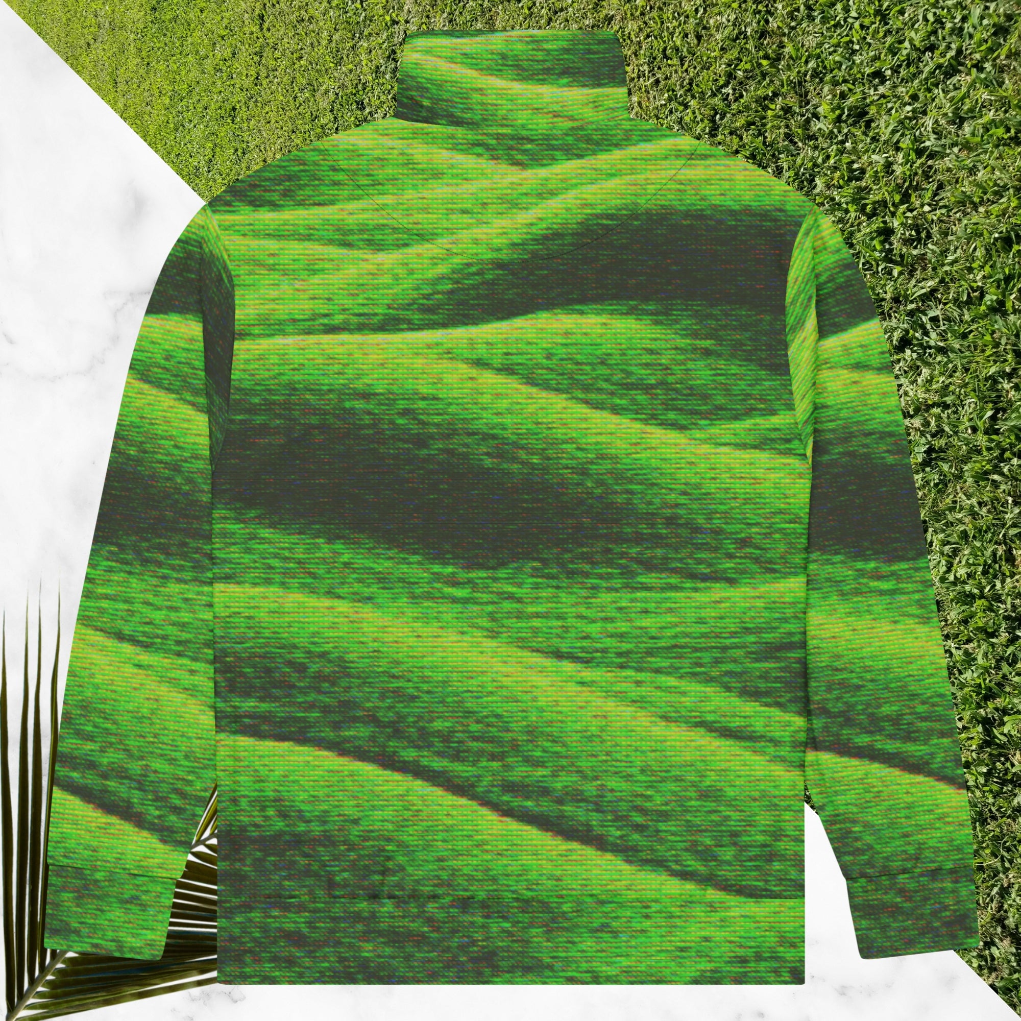 Primarily green and black full color all over print track jacket depicting grass covered green rolling hills and their shadows overlayed with detailed v h s and retro t v distortion with a green and blue Neon Pools vaporwave sun and waves emblem on the left chest