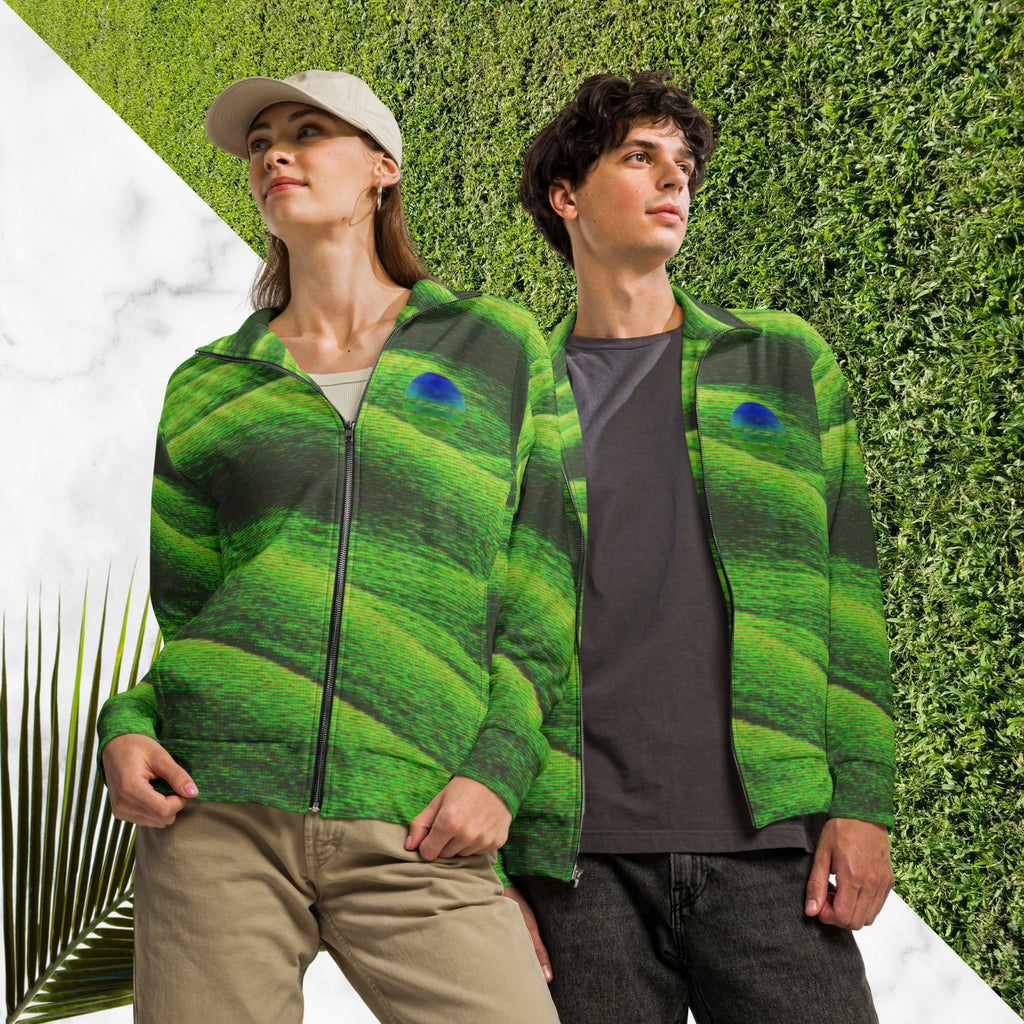 Primarily green and black full color all over print track jacket depicting grass covered green rolling hills and their shadows overlayed with detailed v h s and retro t v distortion with a green and blue Neon Pools vaporwave sun and waves emblem on the left chest