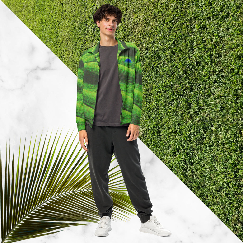 Primarily green and black full color all over print track jacket depicting grass covered green rolling hills and their shadows overlayed with detailed v h s and retro t v distortion with a green and blue Neon Pools vaporwave sun and waves emblem on the left chest