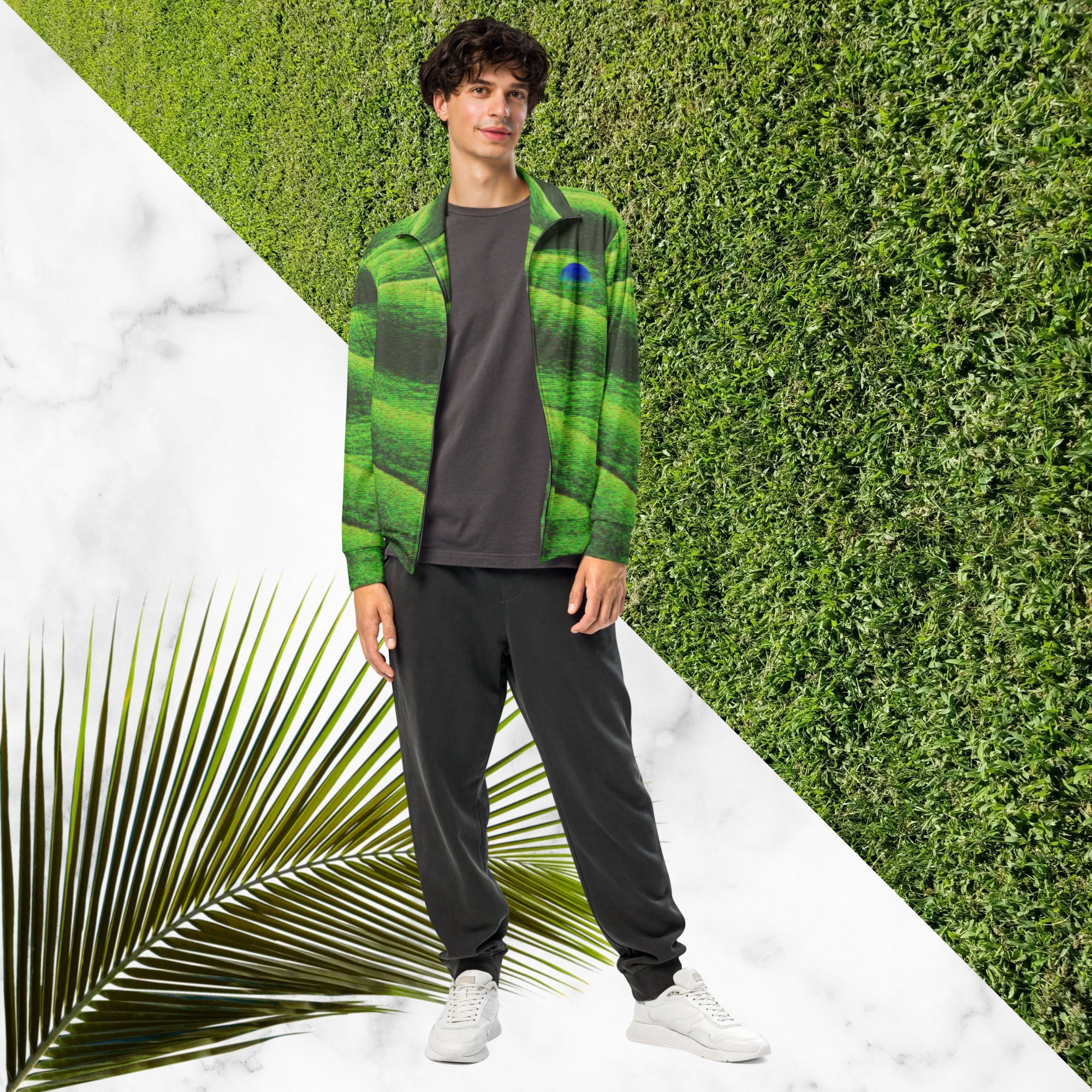 Primarily green and black full color all over print track jacket depicting grass covered green rolling hills and their shadows overlayed with detailed v h s and retro t v distortion with a green and blue Neon Pools vaporwave sun and waves emblem on the left chest