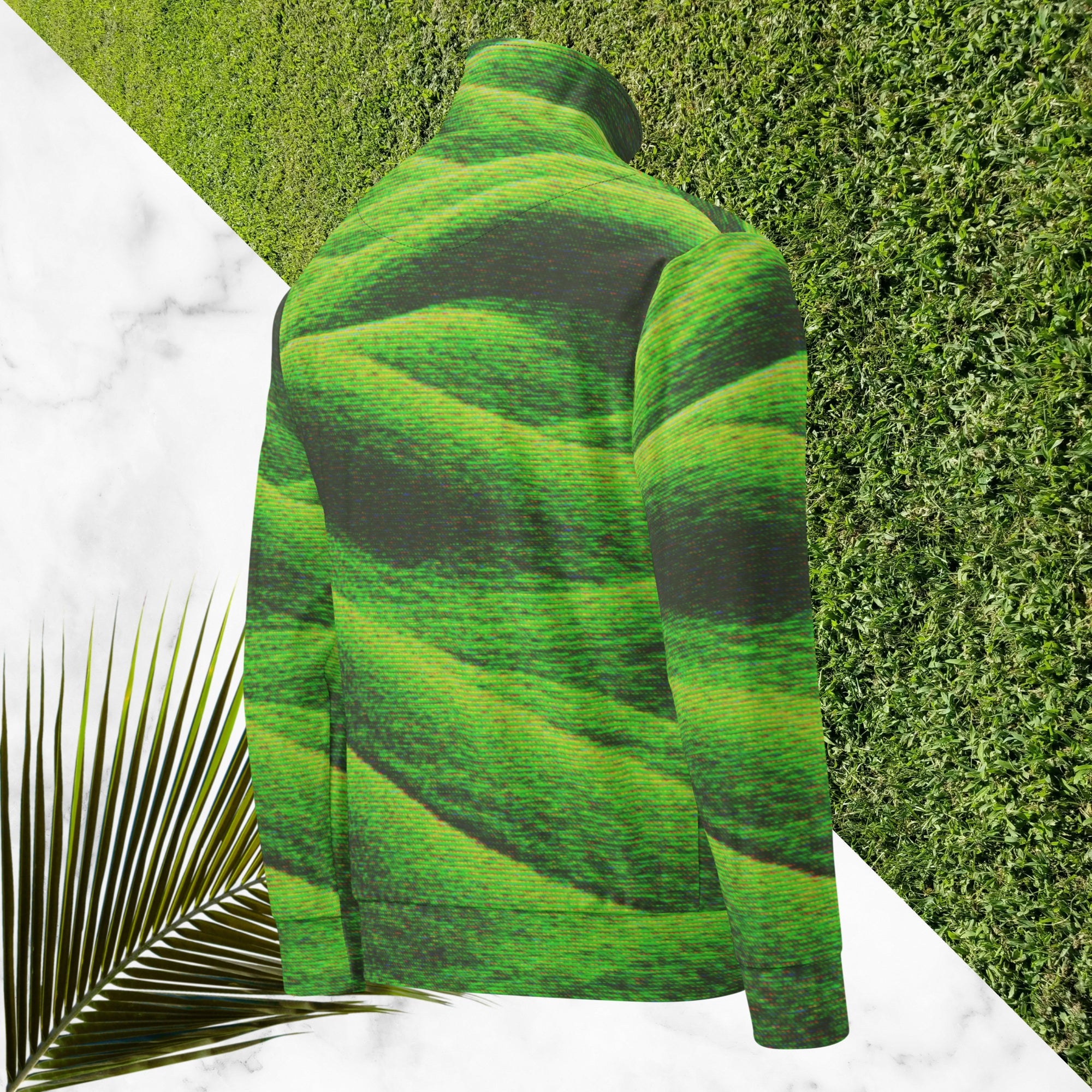 Primarily green and black full color all over print track jacket depicting grass covered green rolling hills and their shadows overlayed with detailed v h s and retro t v distortion with a green and blue Neon Pools vaporwave sun and waves emblem on the left chest