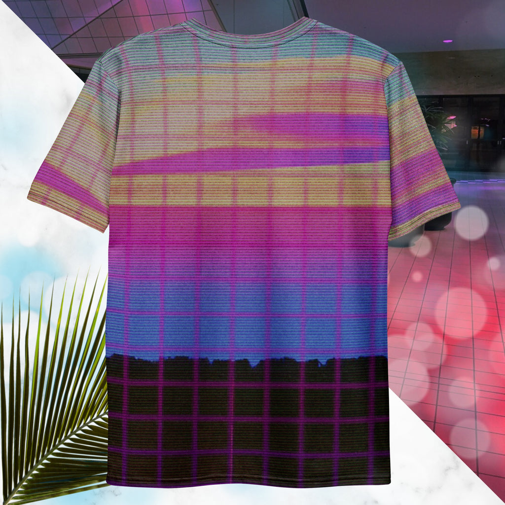 Multicolored all over print graphic t-shirt depicting a retro style grainy c g i image of a pink orange and yellow sunset with visible blue sky at the top sunset over pink to blue gradient water with a foreground of a black rocky cliff overlayed with a pink blurry grid and detailed v h s scanlines and distortion and a neon pools retro zigzag