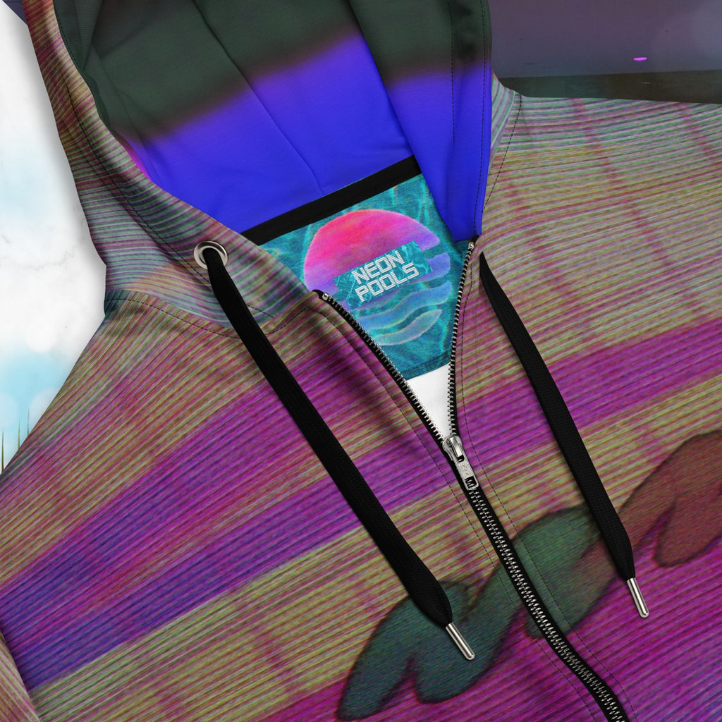 Closeup of neckline and Neon Pools logo insignia on multicolor all over print zip hoodie with digital ocean sunset water fades rom blue to pink black rocky cliff at bottom overlayed with pink grid and Neon Pools abstract zigzag on front with detailed grainy VHS CRT TV distortion and neon blue and darkened version of same image in inner hood