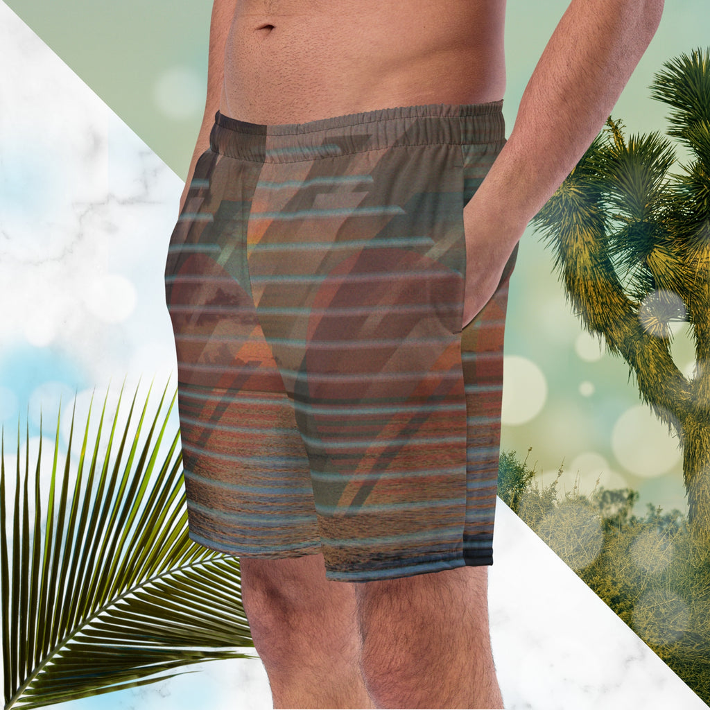 Full color all over print swim trunks with retro ocean sunset with shimmering water photo overlayed with transparent stripes and graphic shapes in a 1980s memphis design style partial stripes and a transparent vaporwave broken sun in coral tone with detailed vhs distortion effects