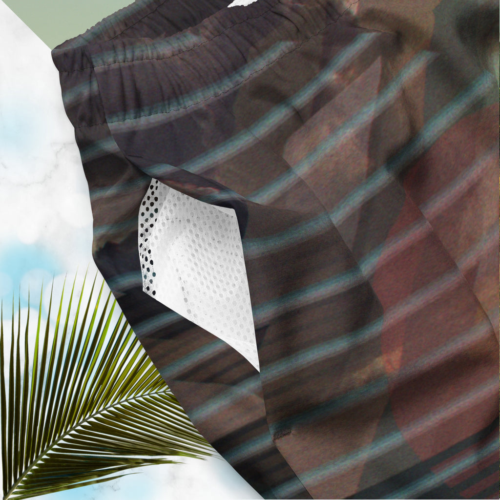 Closeup of pocket on full color all over print swim trunks with retro ocean sunset with shimmering water photo overlayed with transparent stripes and graphic shapes in a 1980s memphis design style partial stripes and a transparent vaporwave broken sun in coral tone with detailed vhs distortion effects
