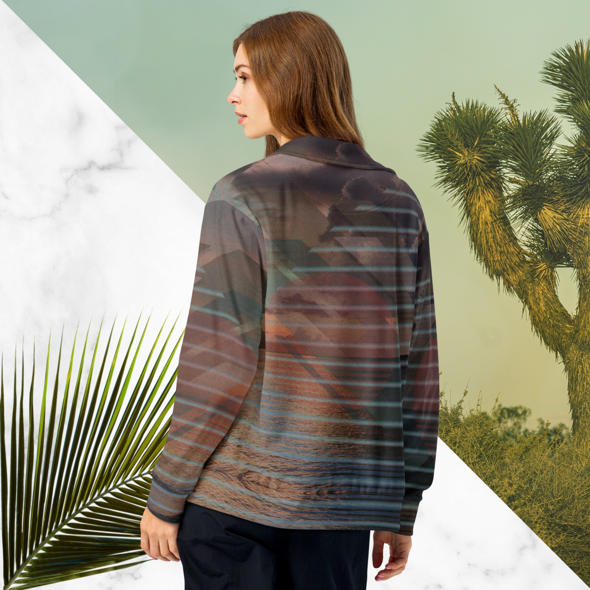 Full color all over print track jacket with retro ocean sunset with shimmering water photo overlayed with transparent stripes and graphic shapes in a 1980s memphis design style partial stripes and a transparent vaporwave broken sun in coral tone neon pools broken sun and waves logo emblem at left chest