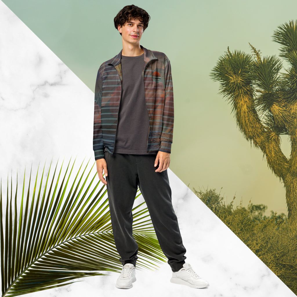 Full color all over print track jacket with retro ocean sunset with shimmering water photo overlayed with transparent stripes and graphic shapes in a 1980s memphis design style partial stripes and a transparent vaporwave broken sun in coral tone neon pools broken sun and waves logo emblem at left chest