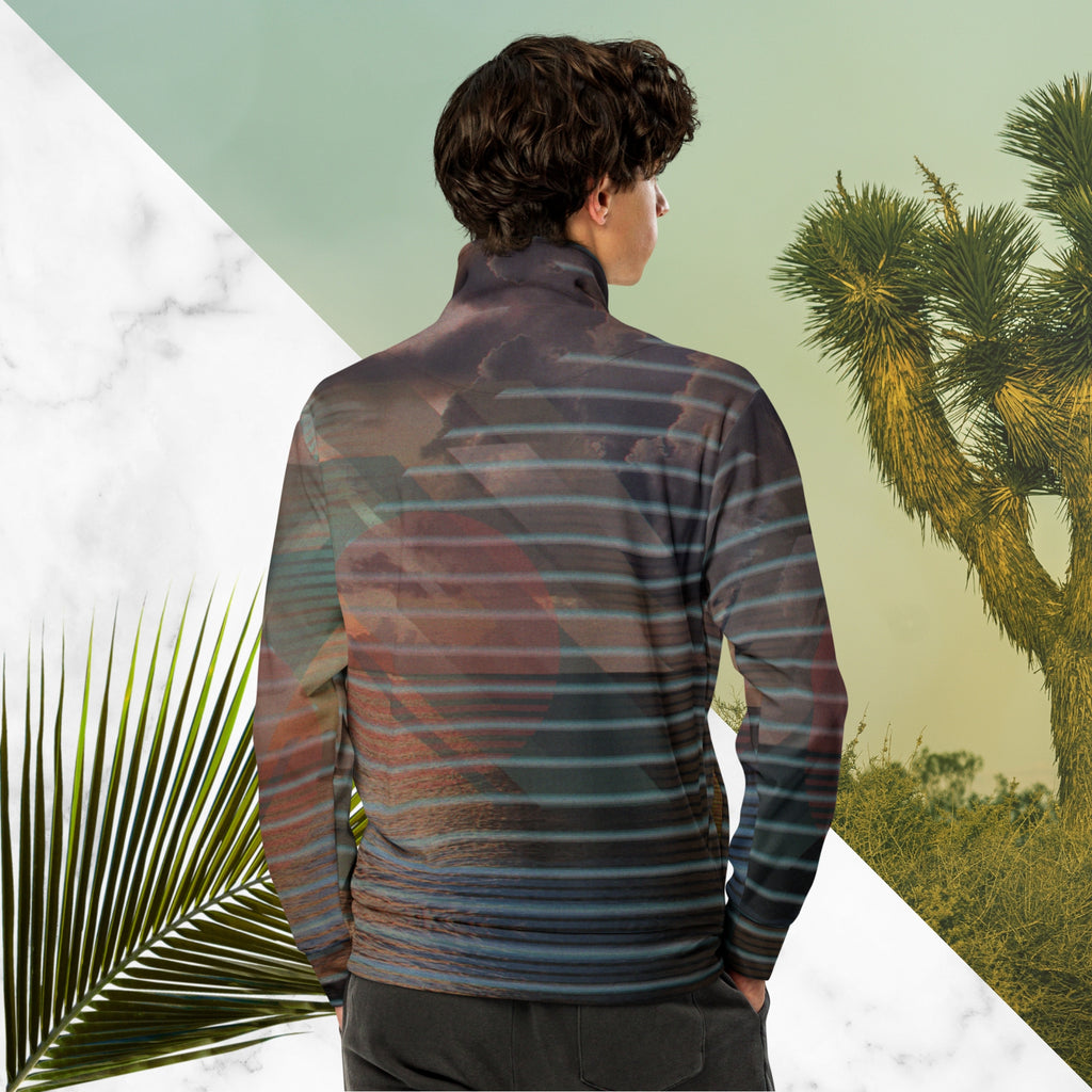 Full color all over print track jacket with retro ocean sunset with shimmering water photo overlayed with transparent stripes and graphic shapes in a 1980s memphis design style partial stripes and a transparent vaporwave broken sun in coral tone neon pools broken sun and waves logo emblem at left chest