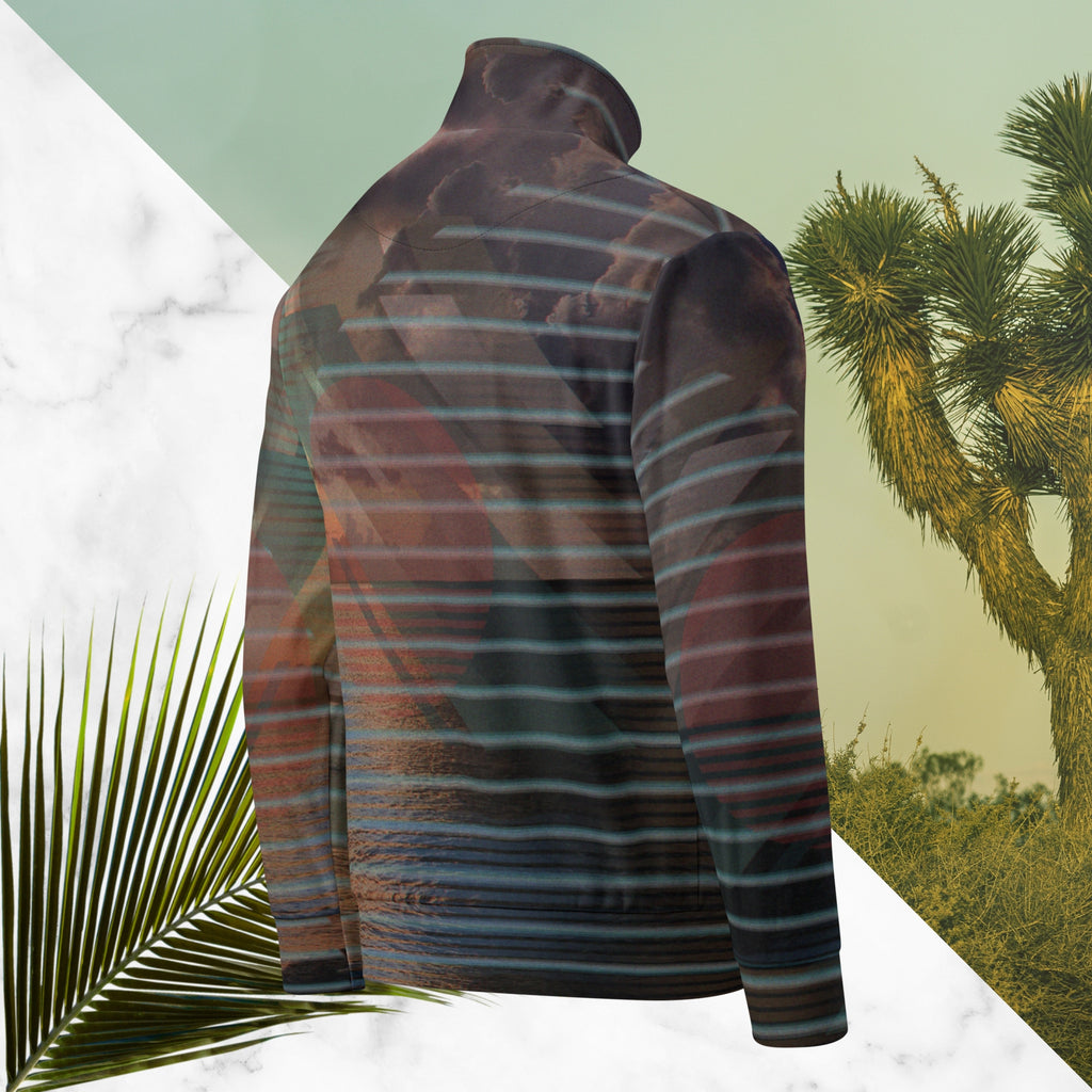 Full color all over print track jacket with retro ocean sunset with shimmering water photo overlayed with transparent stripes and graphic shapes in a 1980s memphis design style partial stripes and a transparent vaporwave broken sun in coral tone neon pools broken sun and waves logo emblem at left chest