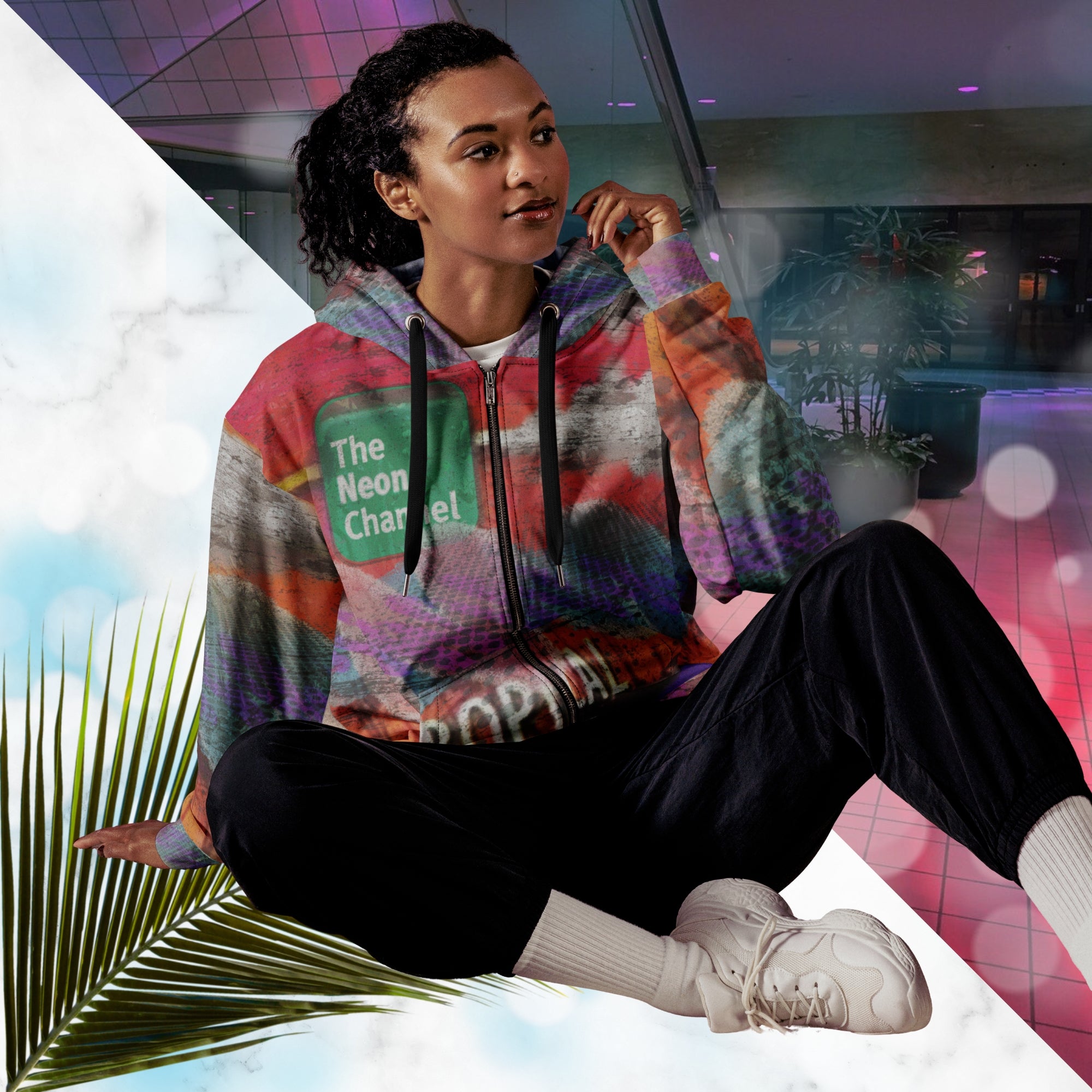 Vibrant multicolored all over print zip hoodie with retro tv weather broadcast graphics featuring a logo that says The Neon Channel and the words tropical update teal and purple retro zigzag tropical sunset in brilliant oranges and reds with clouds 90s distortion blue dots graphics