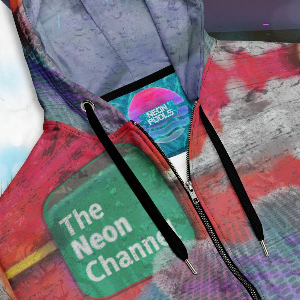 Closeup of neck line and Neon Pools insignia inner label patch on vibrant multicolored all over print zip hoodie with retro tv weather broadcast graphics featuring a logo that says The Neon Channel and the words tropical update teal and purple retro zigzag tropical sunset in brilliant oranges and reds with clouds 90s distortion blue dots graphics