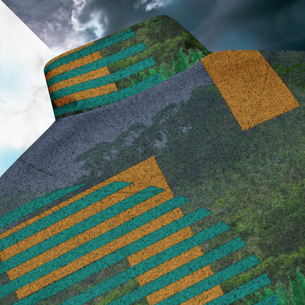Closeup of back collar and stitching on multicolored all over print track jacket depicting a dense lush jungle overlayed and interlaced with bold solid orange abstract graphics teal rounded modern stripes and a dark gray stormy sky at the top overlayed with retro inspired static similar to video degradation on an old television set with a Neon Pools magenta and blue vaporwave sun and waves emblem at left chest