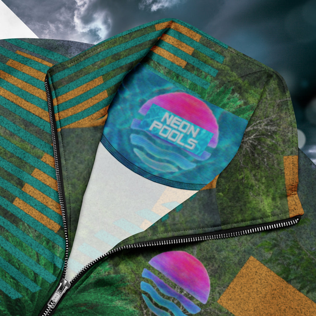 Closeup of neckline and Neon Pools inner logo and insignia on multicolored all over print track jacket depicting a dense lush jungle overlayed and interlaced with bold solid orange abstract graphics teal rounded modern stripes and a dark gray stormy sky at the top overlayed with retro inspired static similar to video degradation on an old television set with a Neon Pools magenta and blue vaporwave sun and waves emblem at left chest