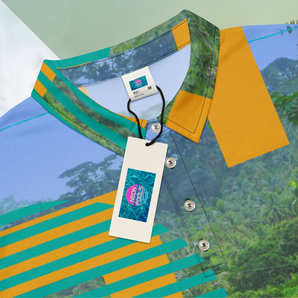 Closeup of collar inner tag and Neon Pools logo retail tag on primarily green orange teal and misty blue shirt depicting a dense lush misty jungle overlayed and interlaced with 3d ferns monstera plants and bold solid orange abstract graphic shapes bold teal rounded modern stripes and a hazy blue sky at the top